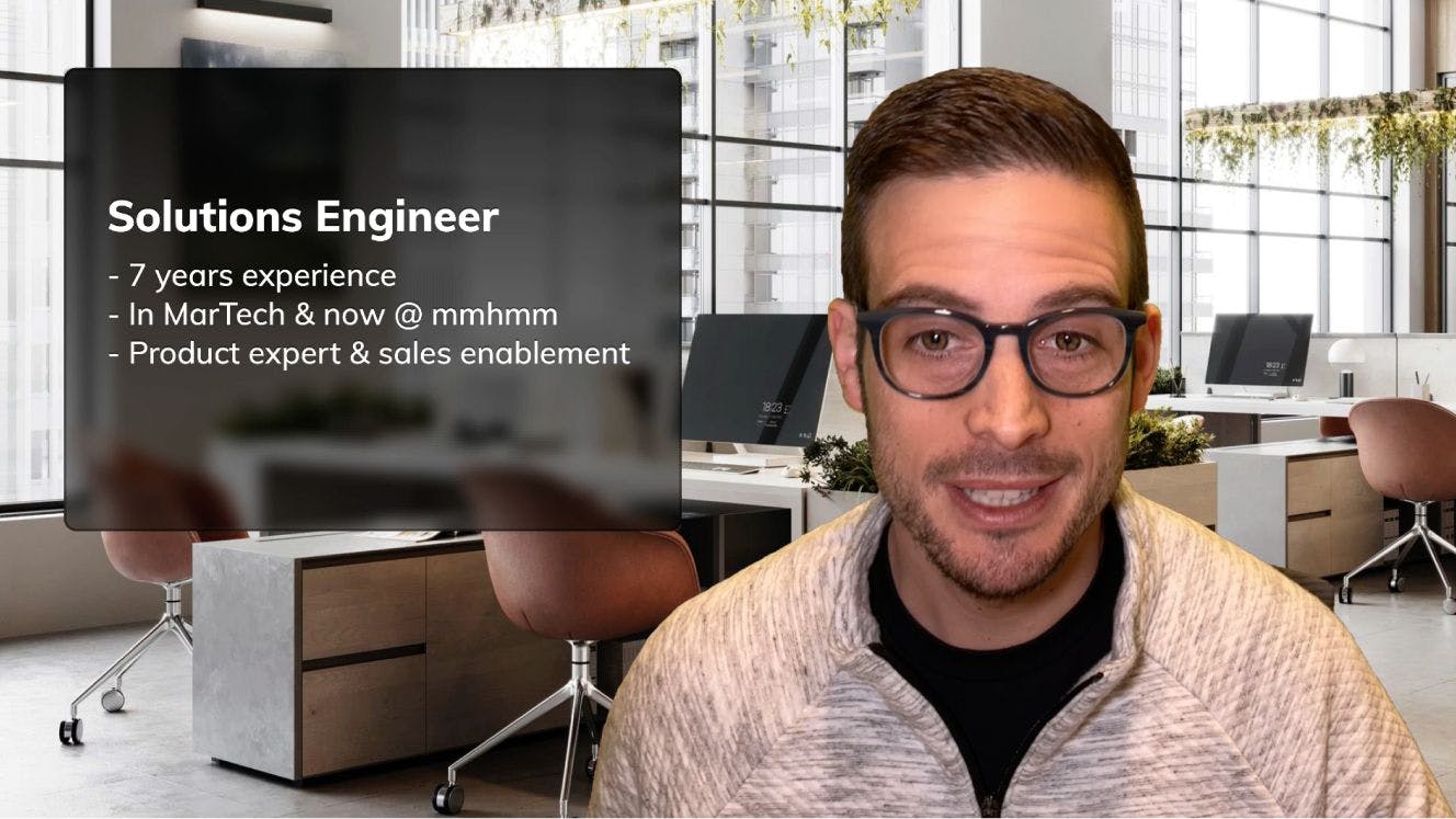 Man with dark hair and glasses next to a slide that list his accomplishments as a Solutions Engineer