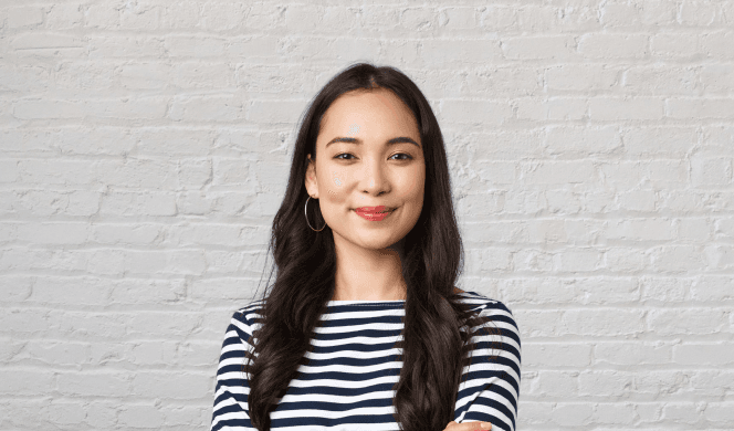 Person with long hair in white bricks background